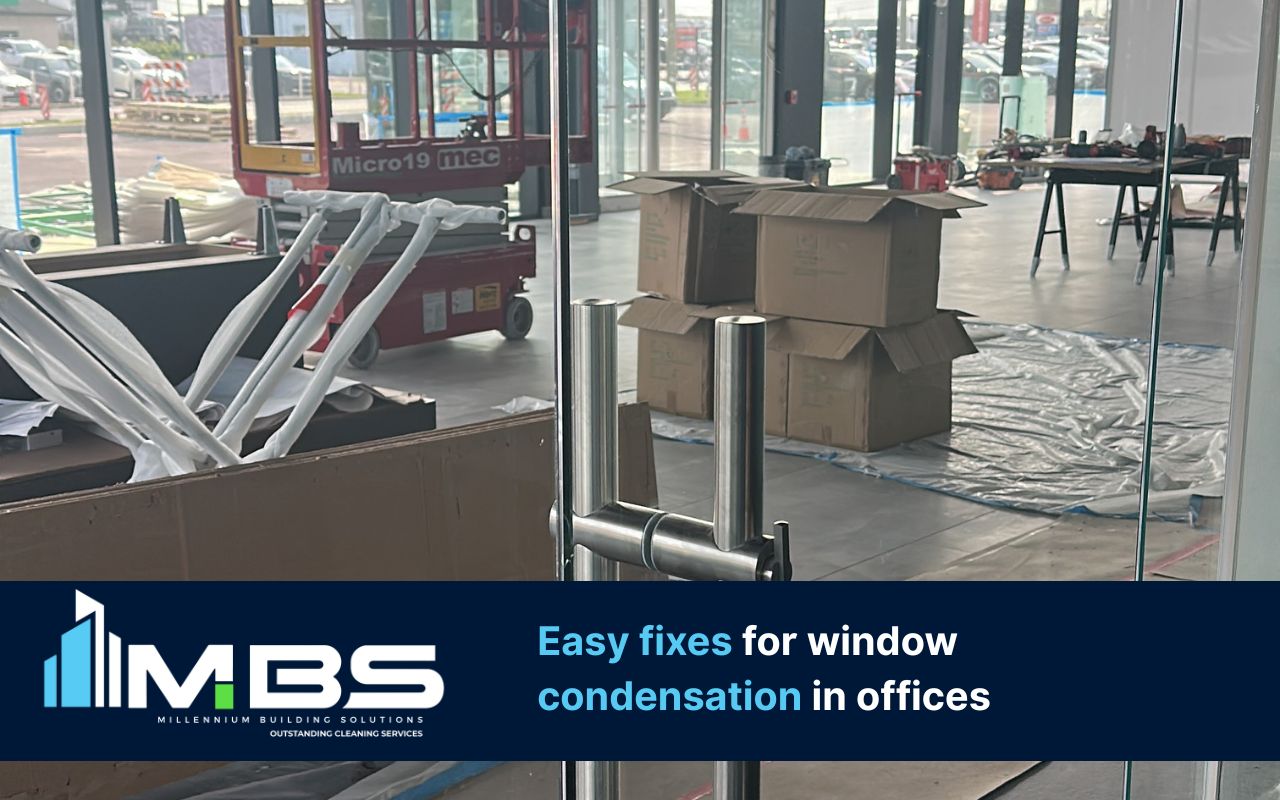 Window condensation in offices on interior/exterior glass near a conference room window.